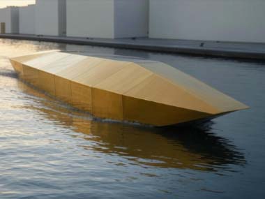 boat, modern, design, golden, reflective, sleek, minimalist, contemporary, water, sculpture, art, architecture, unique, geometric, angular, metallic, futuristic, innovation, luxury, installation, waterfront, display, exhibit, creative, structure